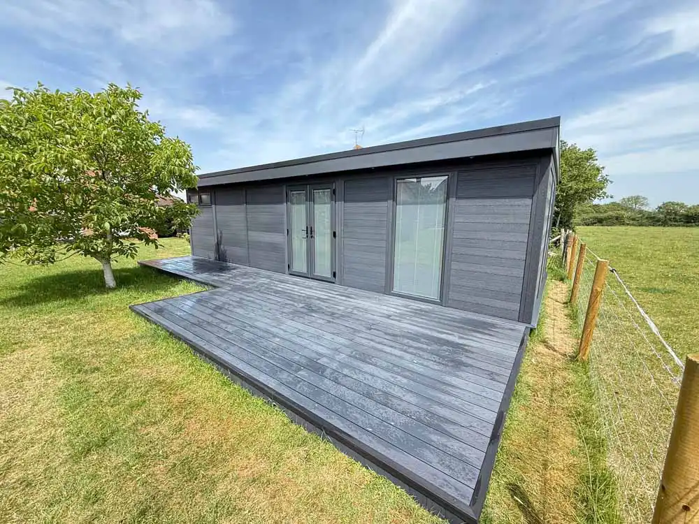 Low-maintenance composite decking matching a garden room