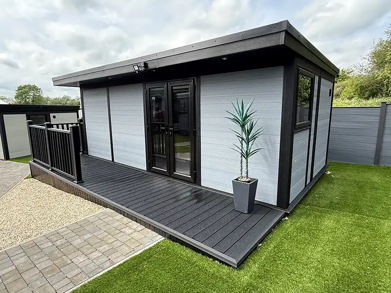 Grey composite annexe with double doors and a composite deck with railings