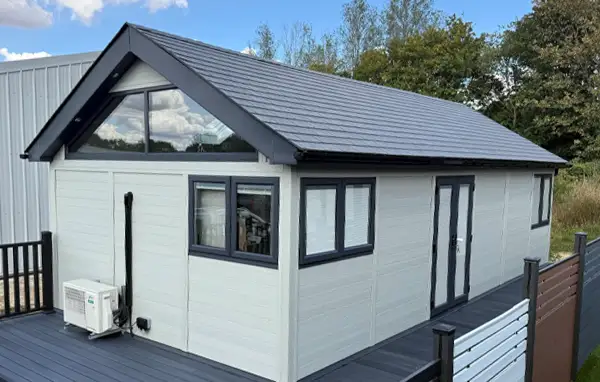 Annexe with a dual pitched tiled roof and a glass gable end