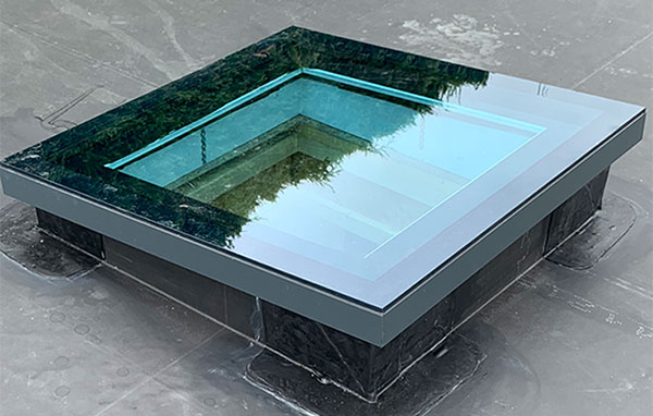 Flat glass roof light fitted to a garden room roof