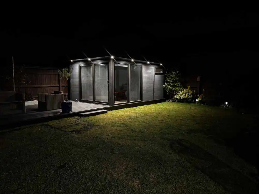 Composite garden room lit up at night