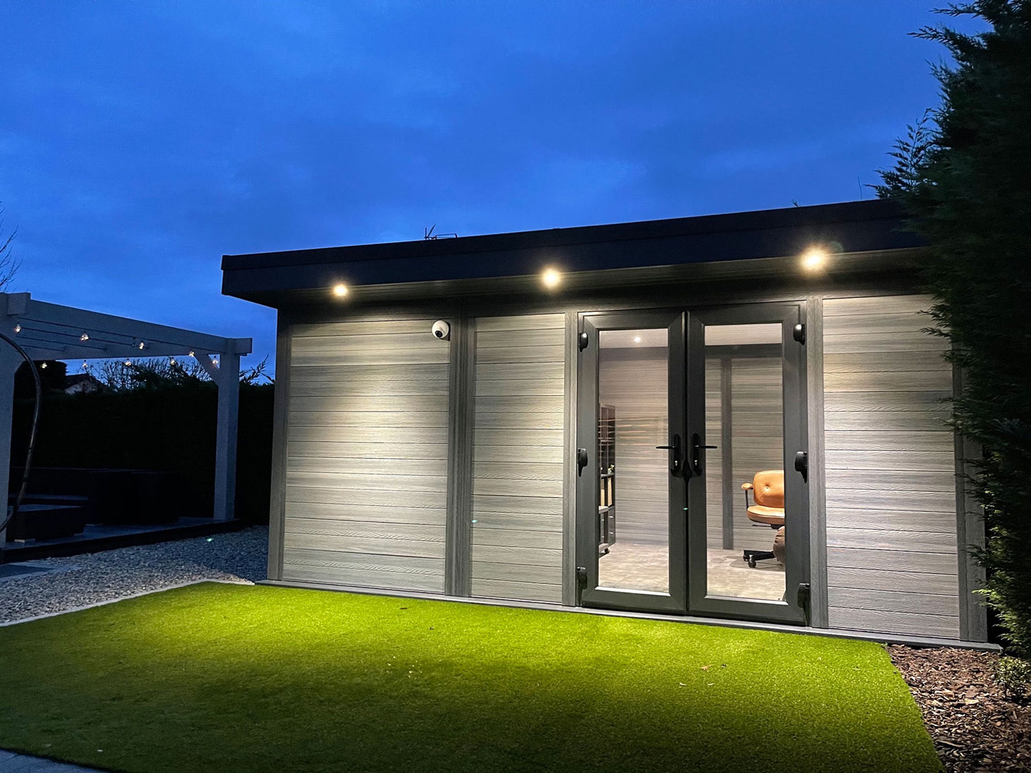 Light Grey Composite Garden Building At Dusk