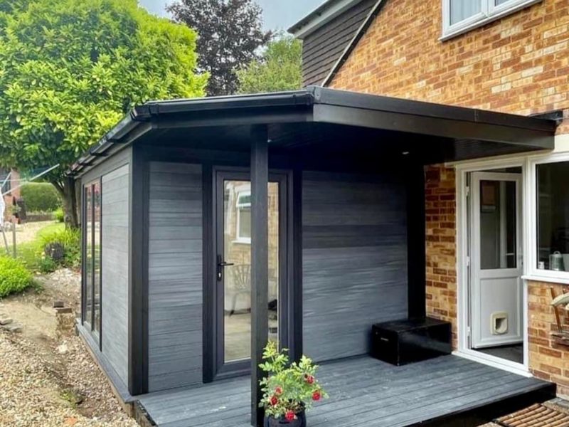 Attached Composite Garden Building With Side Canopy And Small Decking Area