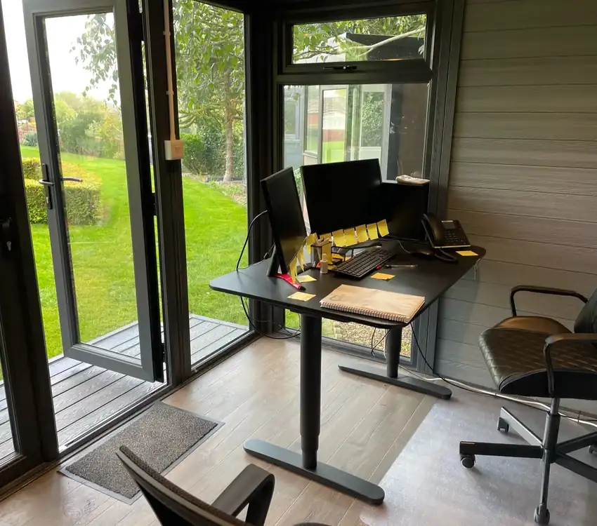 Composite garden office with standing desk and garden view