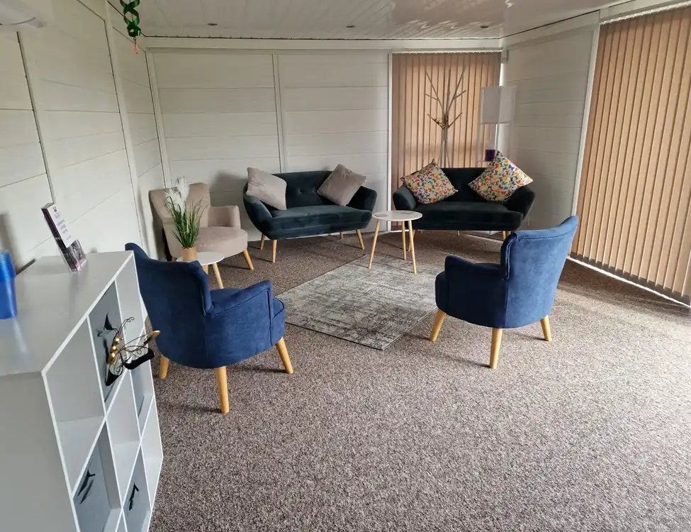 Composite garden room therapy room with blue armchairs